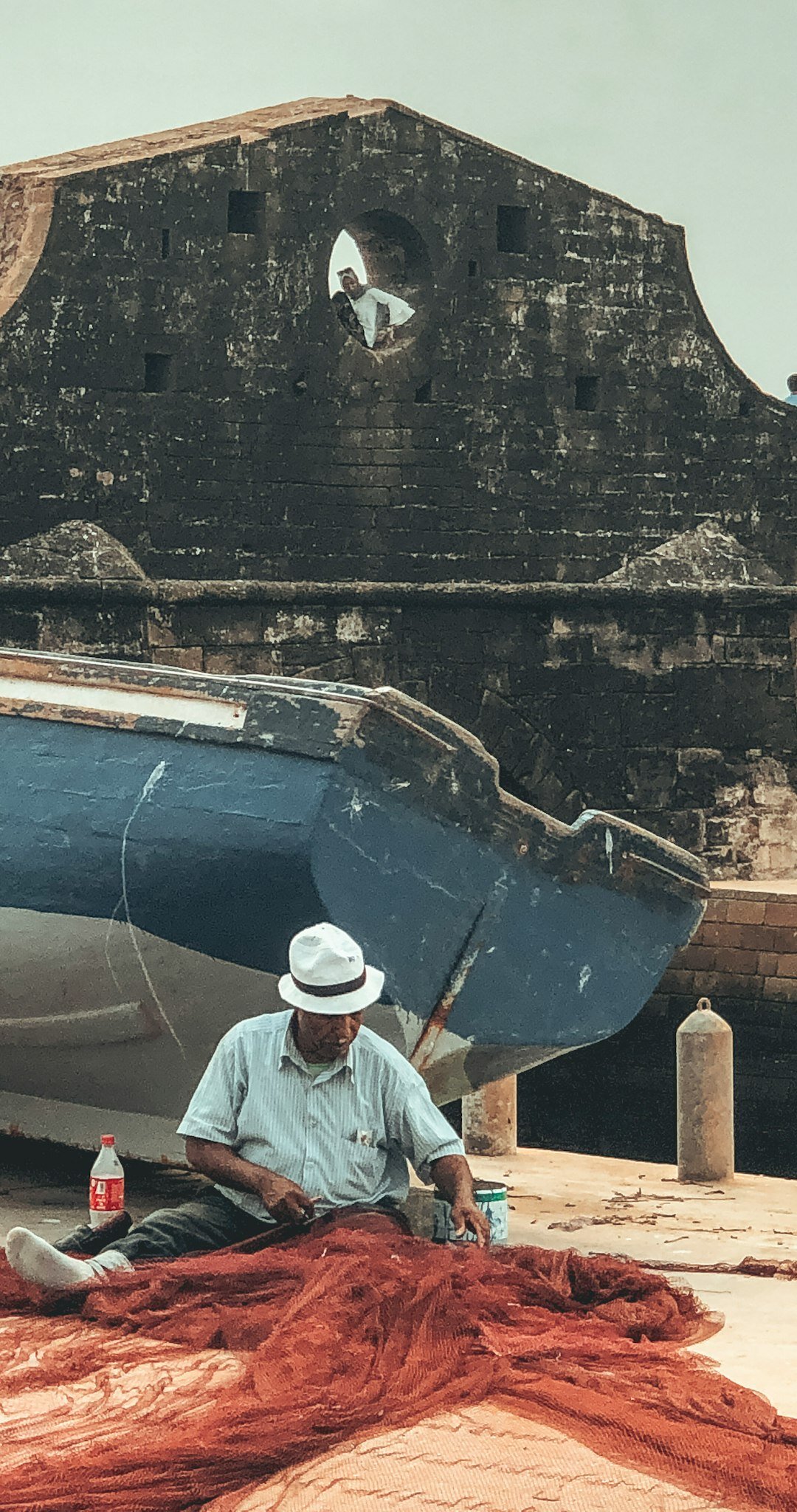 elderly man repairing boat